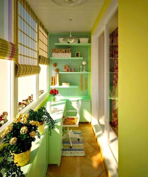 small balcony, wooden floor, green lime accent wall, peg boards, floating shelves, table, white chair, green cabinet, stick shade