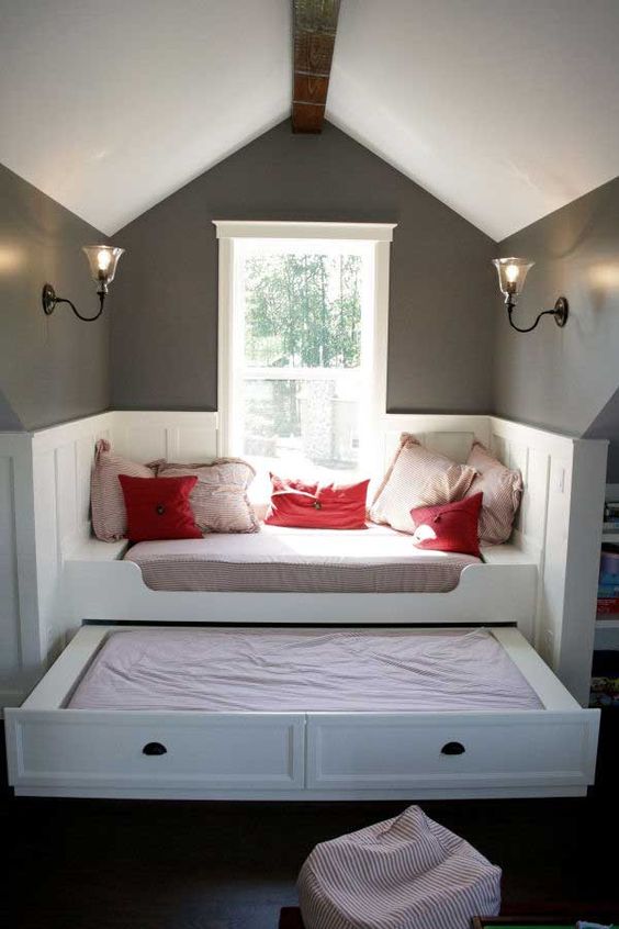 window nook with arch ceiling, grey top half wall, white molding wall, white bench with cushion, sliding bed under