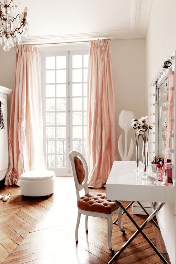 bedroom, chevron wood flooring, white wall, pink curtain, white desk, parisian chair, mirror with bulbs