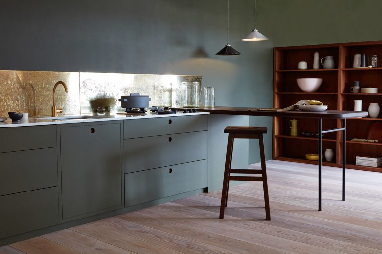 kitchen with grey built in cabinet, grey wall, ,mirror backsplash, wooden island table bar, wooden stool, pendant