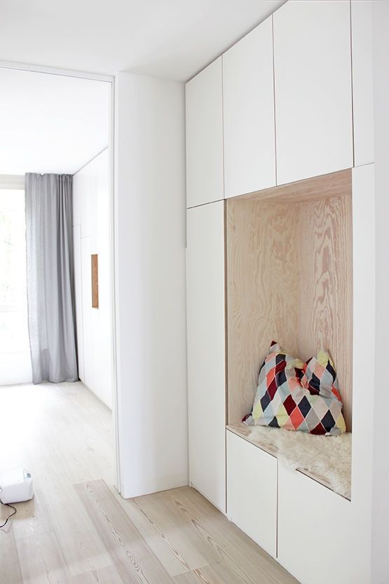 nook in the middle of white cupboard, plyboard side, pillow