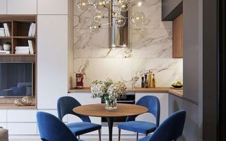 small corner kitchen, grey white cabinet, white marble wall, wooden top, woode  top tulip table, blue velvet chairs, bulubs pendant