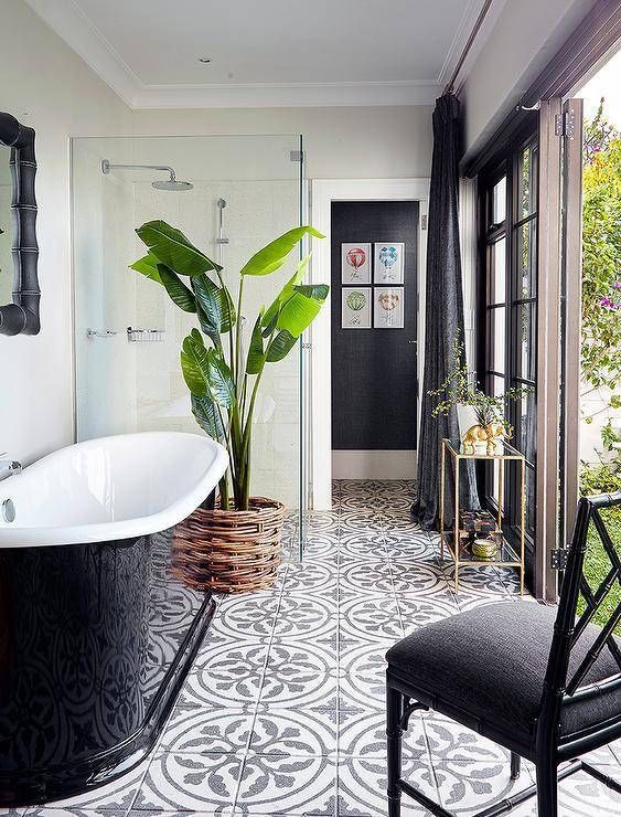 bathroom, white wall, patterned floor tiles, black tub, glass partition, shower, black chairs, golden table