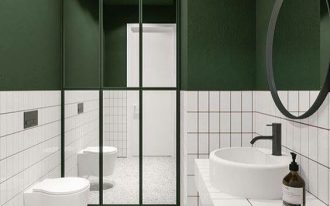 bathroom, white wall tiles, green painted wall, mirror partition, white terrazzo floor, white tiles vanity, white round sink, white floating toilet, round mirror