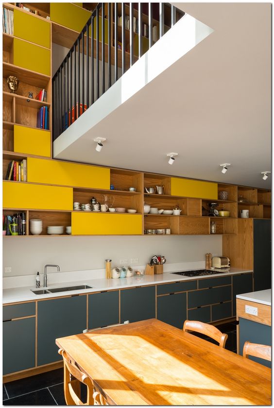 kitchen, black floor tiles, grey bottom cabinet with white top, white backsplash, yellow shelves