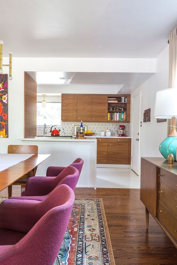 kitchen, white floor, white kitchen top, wooden cabinet, hexagonal backsplash tiles, pendant, dining table with purple chairs