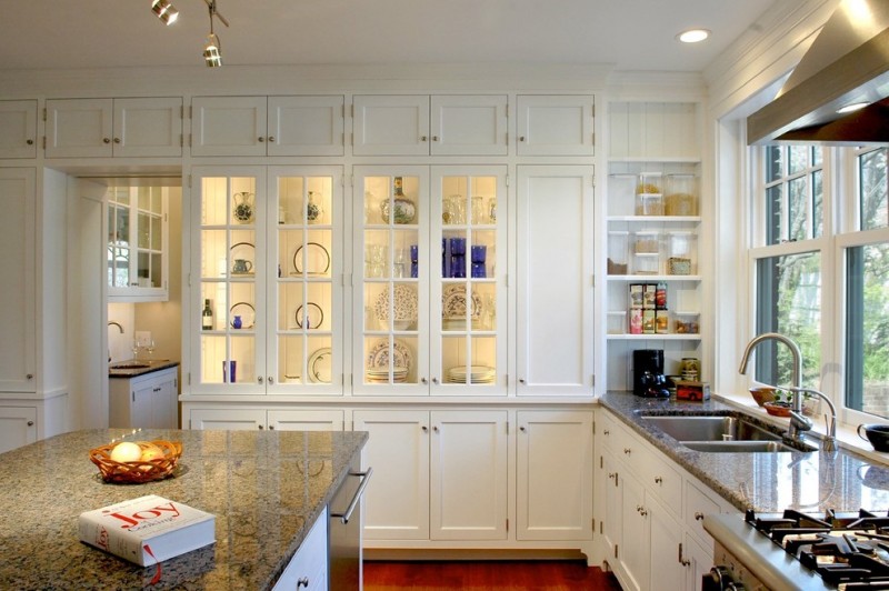 white cabinet with glass door cabinet lighting granite countertop glass windows range hood stove double sink white shelves