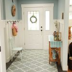 Entrance, Grey Floor Tiles, Grey Rug, Blue Wall, White Tall Wainscoting, Wooden Table, Hooks, White Wooden Chair