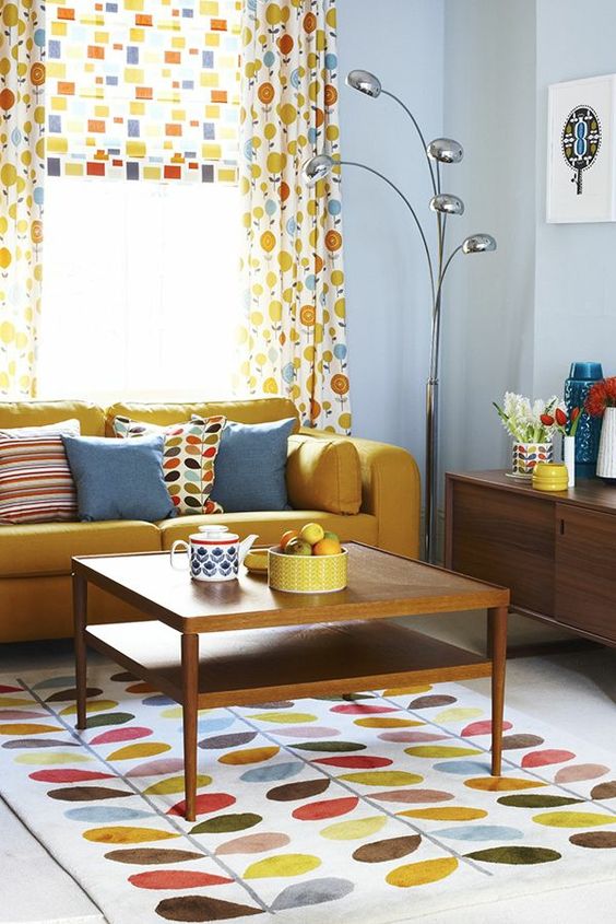 living room, white floor, colorful rug, yellow sofa, light blue wall, wooden cabinet, colorful curtain, wooden coffee table
