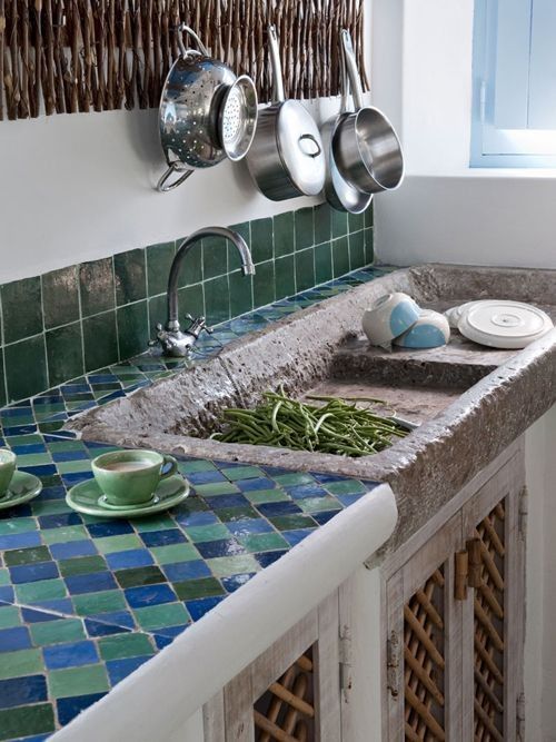 stone sink, blue green tiles kitchen top, greeen tiles backsplash, white wall, white bottom cabinet