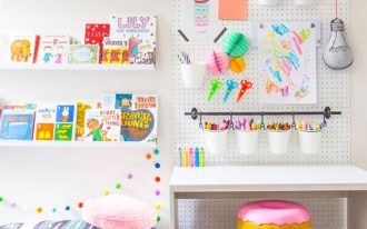 children's study room, white wall, white pegboard, white floating display shelves, grey ru, doughnut stool, white table
