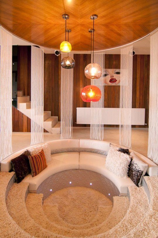 round sunken living room, white sofa, half rug part, white floor, white curtain