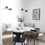 Dining Nook, Wooden Floor, White Wall, Black Sconces, Floating Wooden Bench, White Round Table, Black Chairs