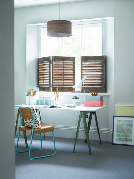brown wooden half window shutters, white wall, white study table, green feet, green metal chair, wooden pendant
