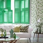 Green Wooden Window Shutters, Green Wallpaper With Flower Pattern, White Marble Floor, White Sofa, Round Glass C