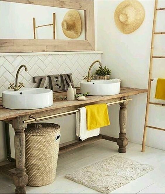 wooden vanity table, white wall, white herringbone backsplash tiles, bamboo rack, rattan basket, white wooden floor