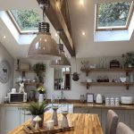 Kitchen, Cream Bottom Cabinet, White Wall, Floating Wooden Shelves, Wooden Table, Cream Chairs, Grey Pendants, Wooden Beam, Glass Ceiling Window