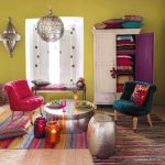 Living Room, Brick Floor, Green Wall, Moroccan Pendant, Silver Ottoman, Silver Coffee Table, Dark Green Chair, White Cupboard, White Window, Colorful Striped Rug