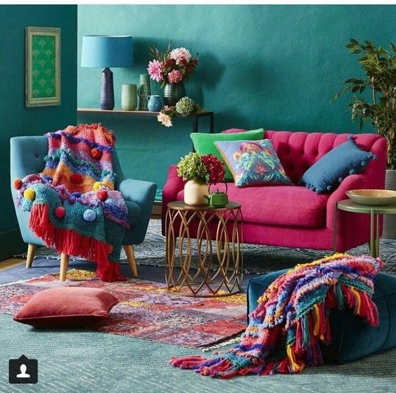 living room, green wall, green rug, green chair, pink sofa, side table, dark gren ottoman