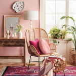 Corner Room, Wooden Floor, Pink Wall, Rattan Chair, Wooden Table, Mirror, Red Rug, Rattan Ottoman