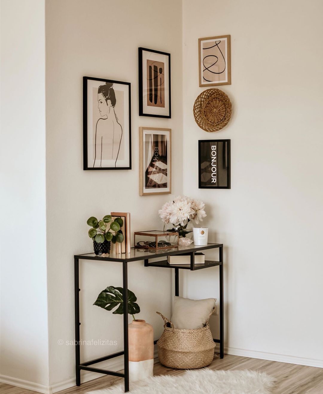 hallway, wooden floor, white wall, black iron framed console table