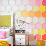 Hexagonal Accent In White Orange, Pink, White Wall, White Floor, White Black Striped Rug, Wooden White Side Cabinet, Golden Floor Lamp