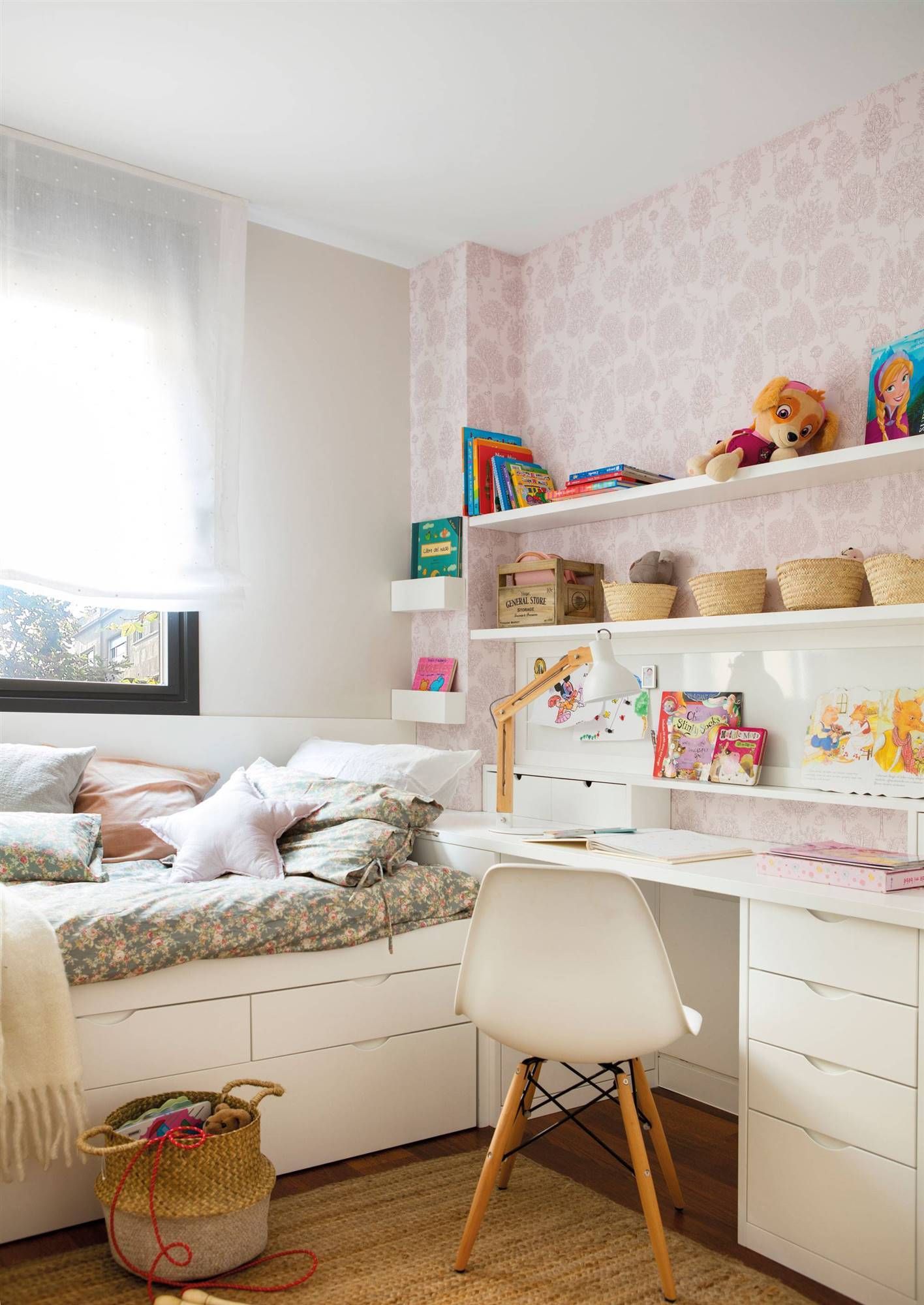 bedroom, wooden floor, white built in table, white bed platform, pink wallpaper, white shelves, rattan rug, white modern chair
