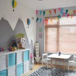 Playroom, Wooden Floor, Patterned Rug, White Blue Shelves, White Table And Chairs