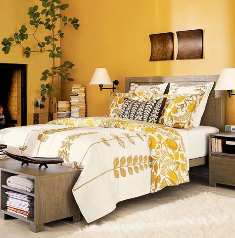 bedroom, wooden floor, yellow wall, wooden bed platform, white bedding, wooden side table, wooden bench