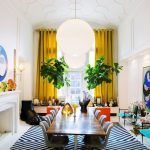 Dining Room, White Floor, White Black Rug, Rectangular Wooden Table, White Table, Yellow Curtain, White Pendants, Blue Chairs, Round Glass Table