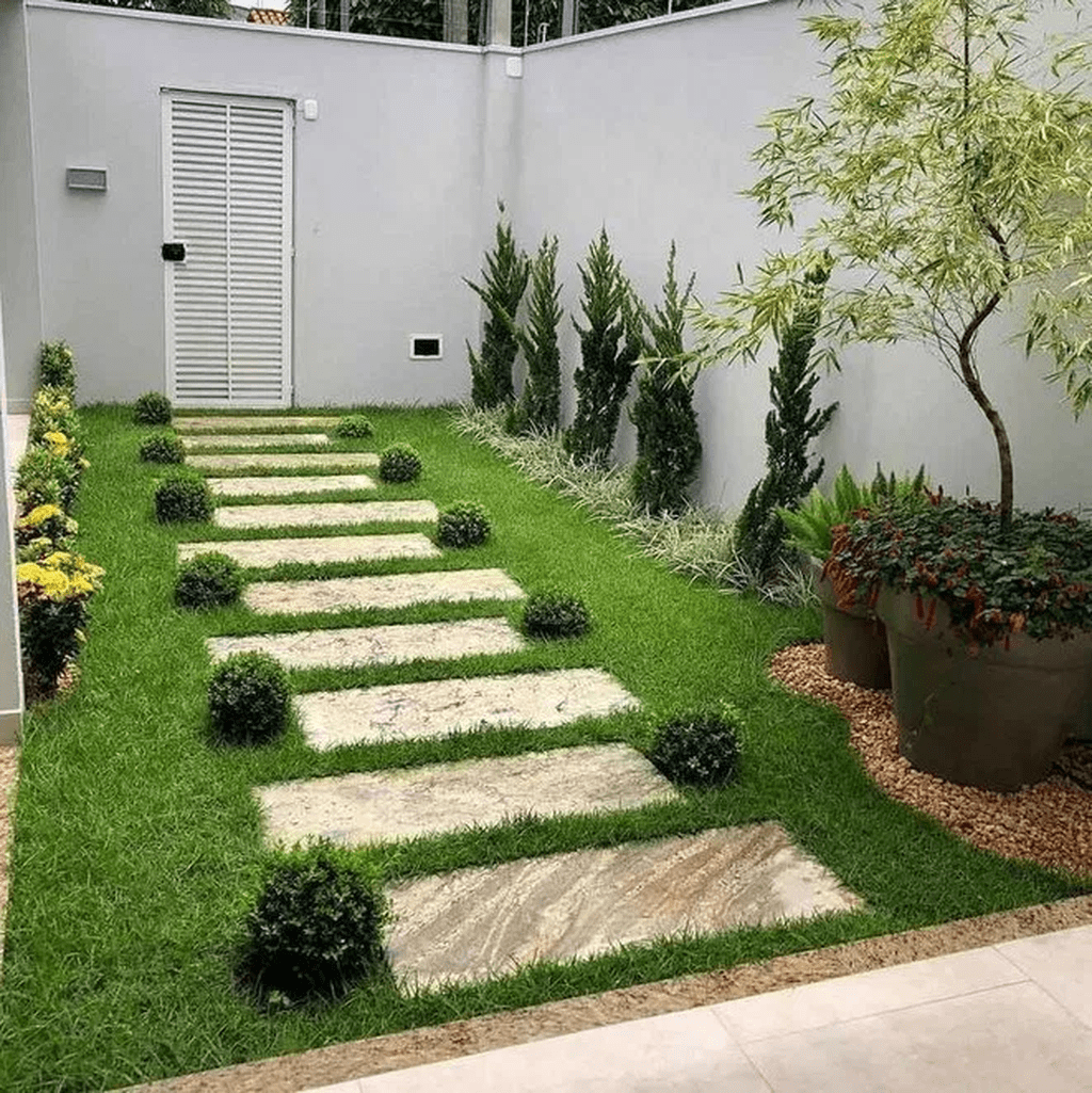 backyard, grass, marble steps, plants, stones, white wall