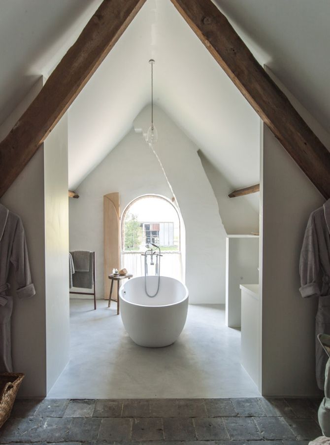 bathroom, white floor, white wall, white vaulted ceiling, wooden beams, arched window