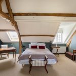Bedroom, Vaulted Ceiling, Blue Wall, White Ceiling, Wooden Beams, Bed, Wooden Table, White Chair, Wooden Bench, Wooden Table