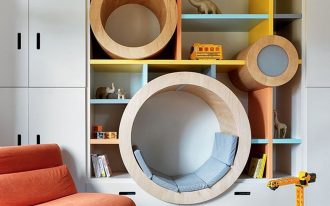 bookshelves, colorful boards, white cabinet, round indented spacein the shelves to sit